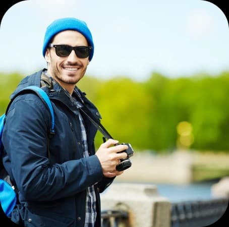 guy holding a camera and smiling guy holding a camera and smiling